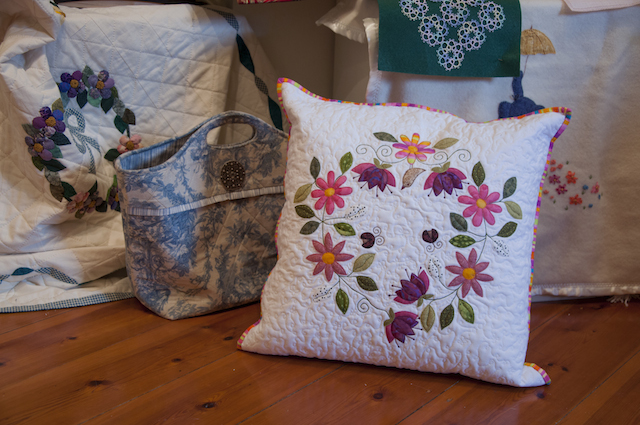 Items from Burra Quilters display in the Bence Room, centre stage Karen Baums’ circle of flowers cushion.