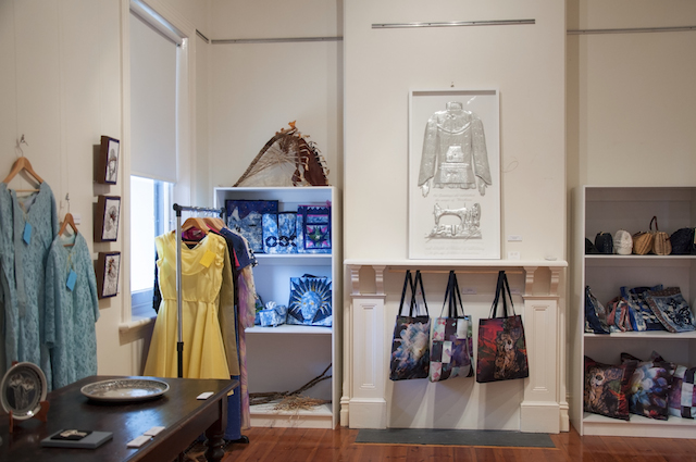 In the Bence Room a glorious array of dresses, bags and accessories, with Karen Genoff’s Daydreams and Needlework, embossed aluminium, glass and text, $3000 above the mantle.