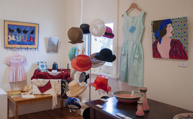 Selection of vintage hats, Ronda Dunstan’s Sentimental Assemblage and gumnut pottery, and, next to a crisp cotton vintage dress Meg Mader’s painting Daphne, $150.