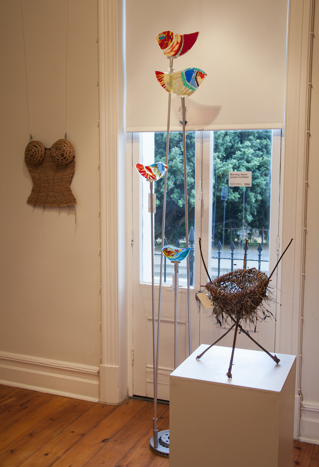 Merea Tsatsoronis’ Corset, $90, glass birds by Lynn Elzinger Henry viewing one of Burra’s beautiful carob trees from the window and Laima Guscia’s A Weave on the Wild Side, $120, made from sticks and seaweed.